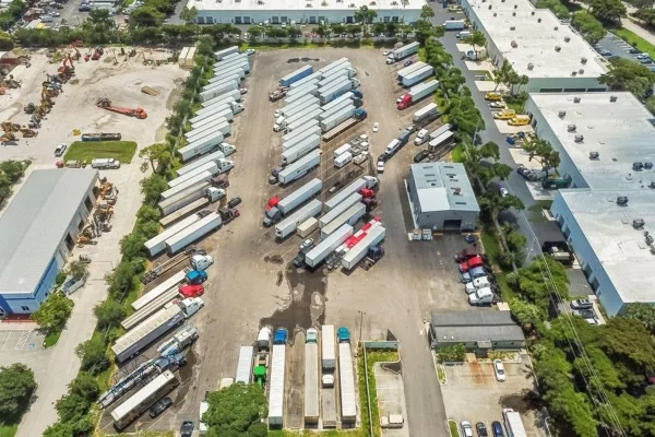 Trucking and logistics terminal with parked tractor trailers